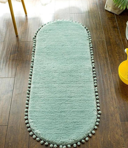Ovale Badmat met Bommelrand van Polyester Antislip